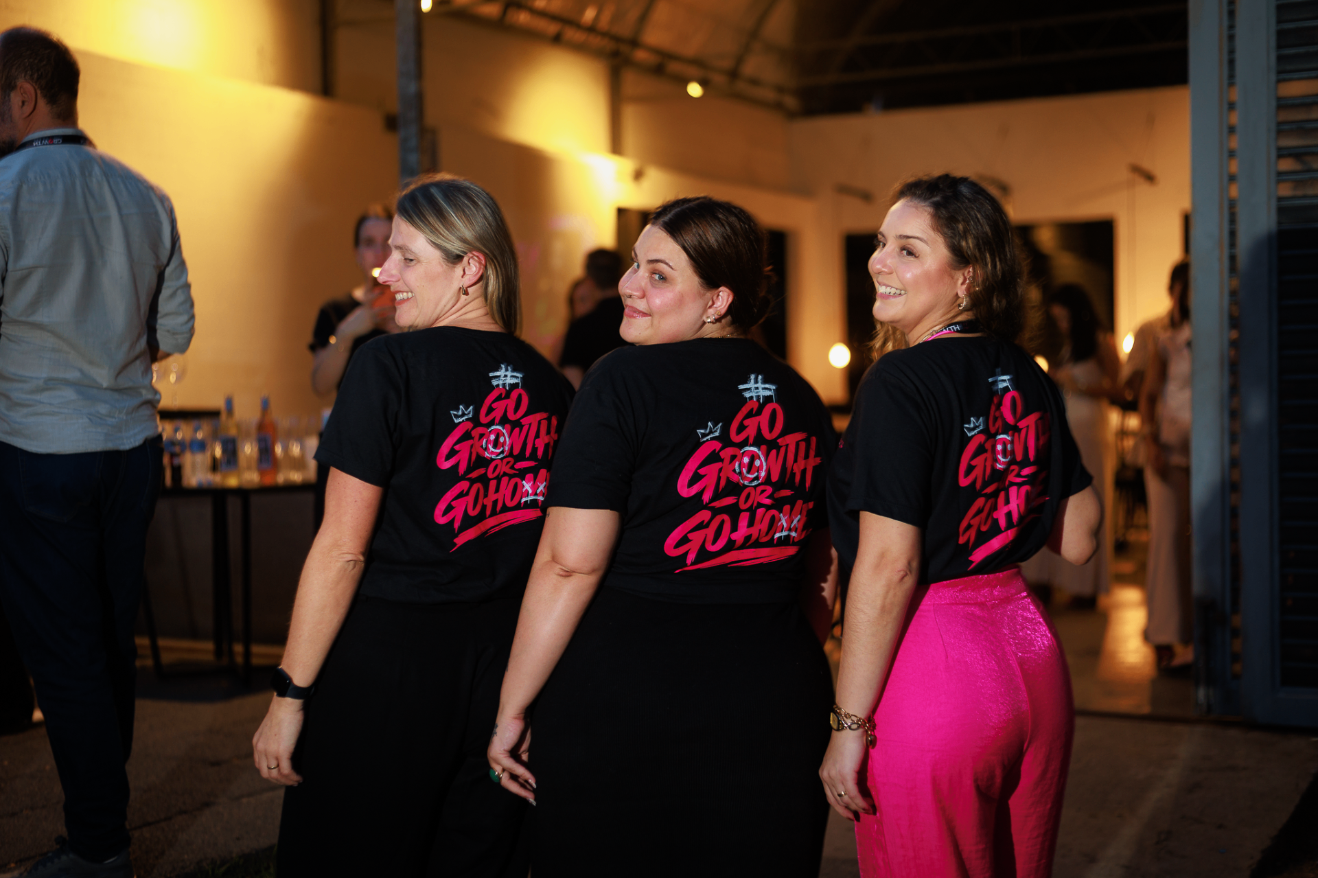 Membros do GrowthClub posando com a camiseta
